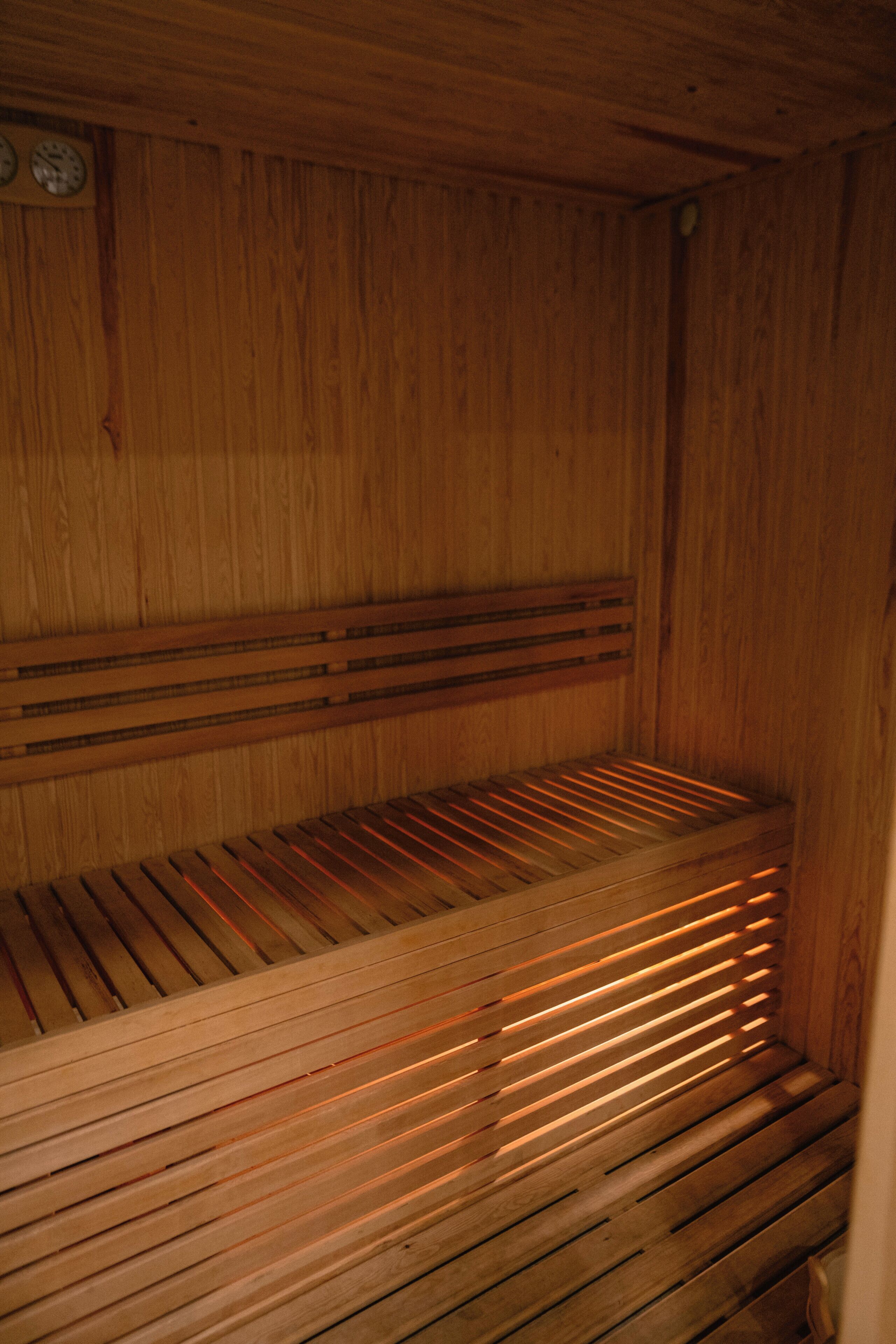 A wooden sauna with slatted benches and a wooden ceiling.