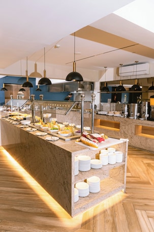 A buffet setup with various food items and a marble counter.