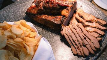 Um prato com carne fatiada e batatas fritas.
