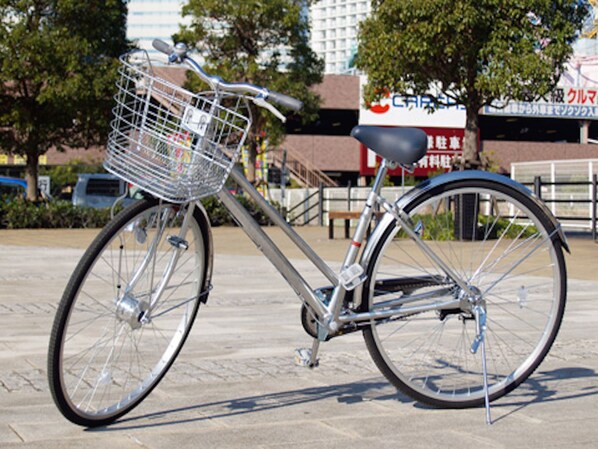 A bicycle with a basket and a seat, parked on a paved surface. - Hotel Crown Hills Katsuta 2 Gou Motomachiten (Hitachinaka)