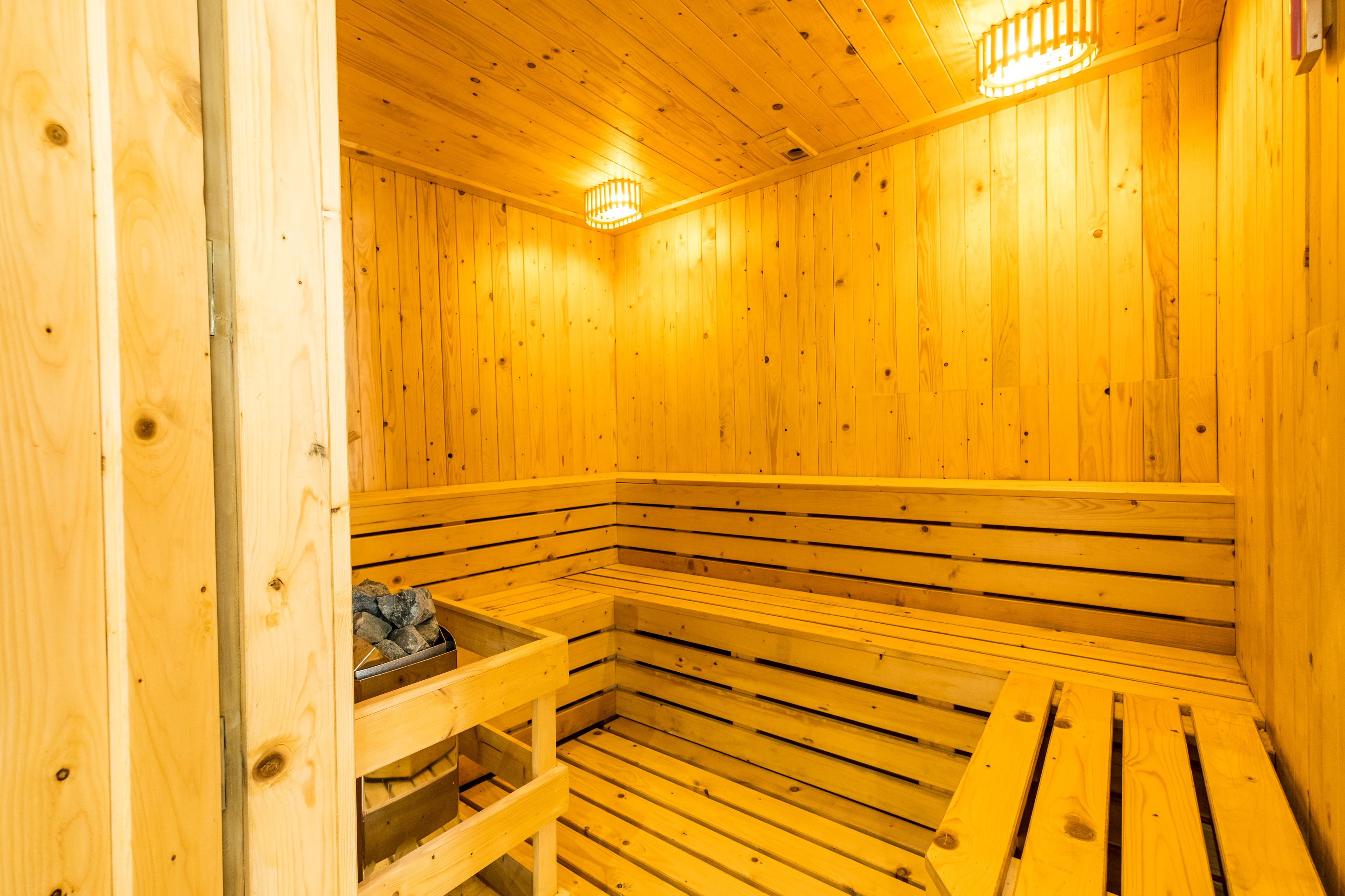 A wooden sauna with benches and a bench seat.