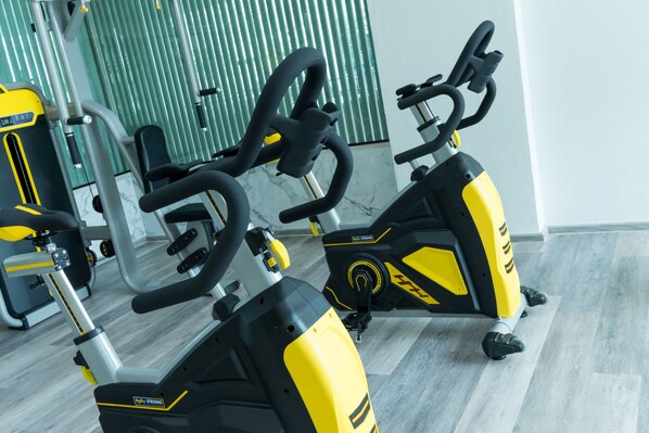 A gym with stationary bikes and exercise equipment.