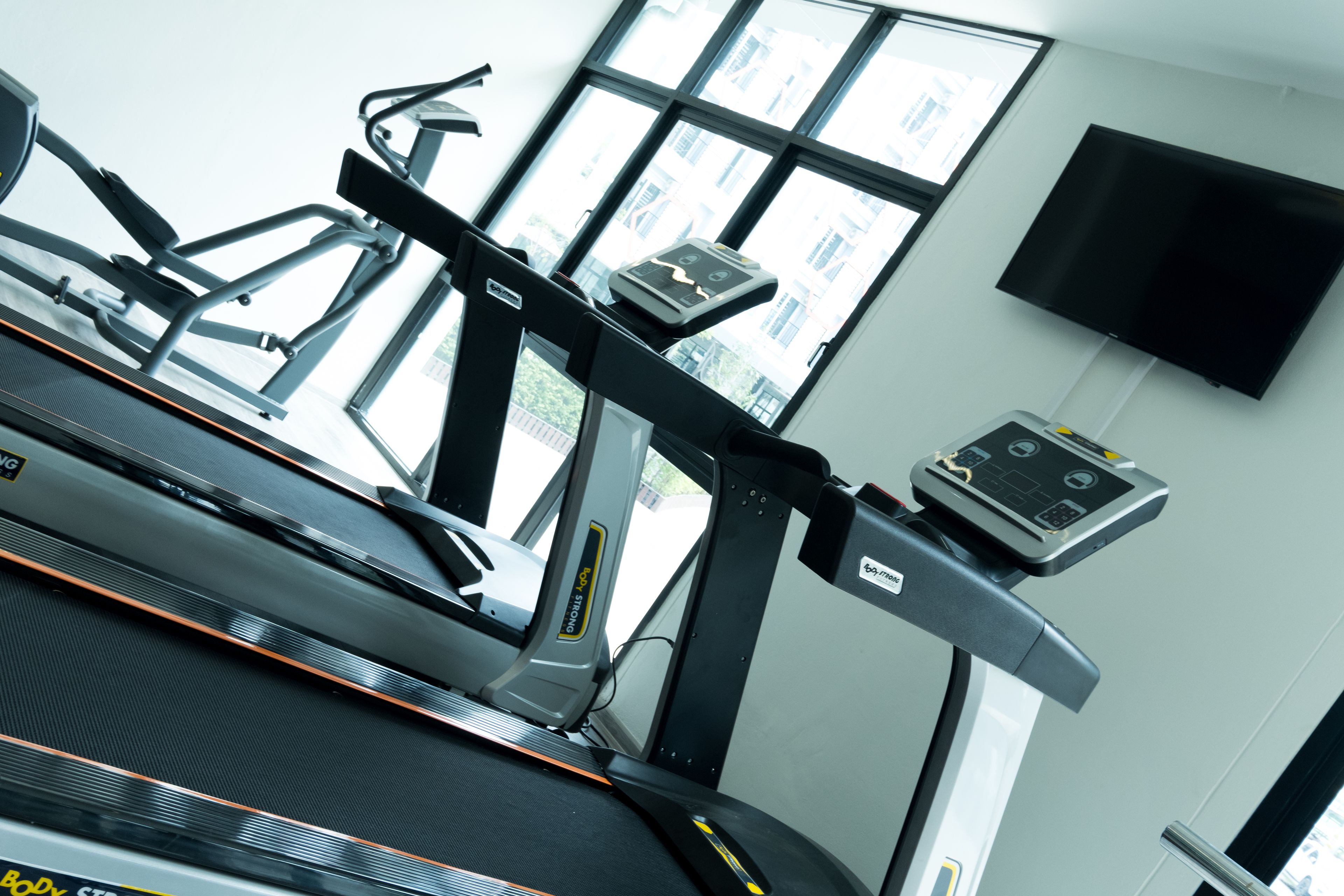 A gym with treadmills, a stationary bike, and a weight machine.