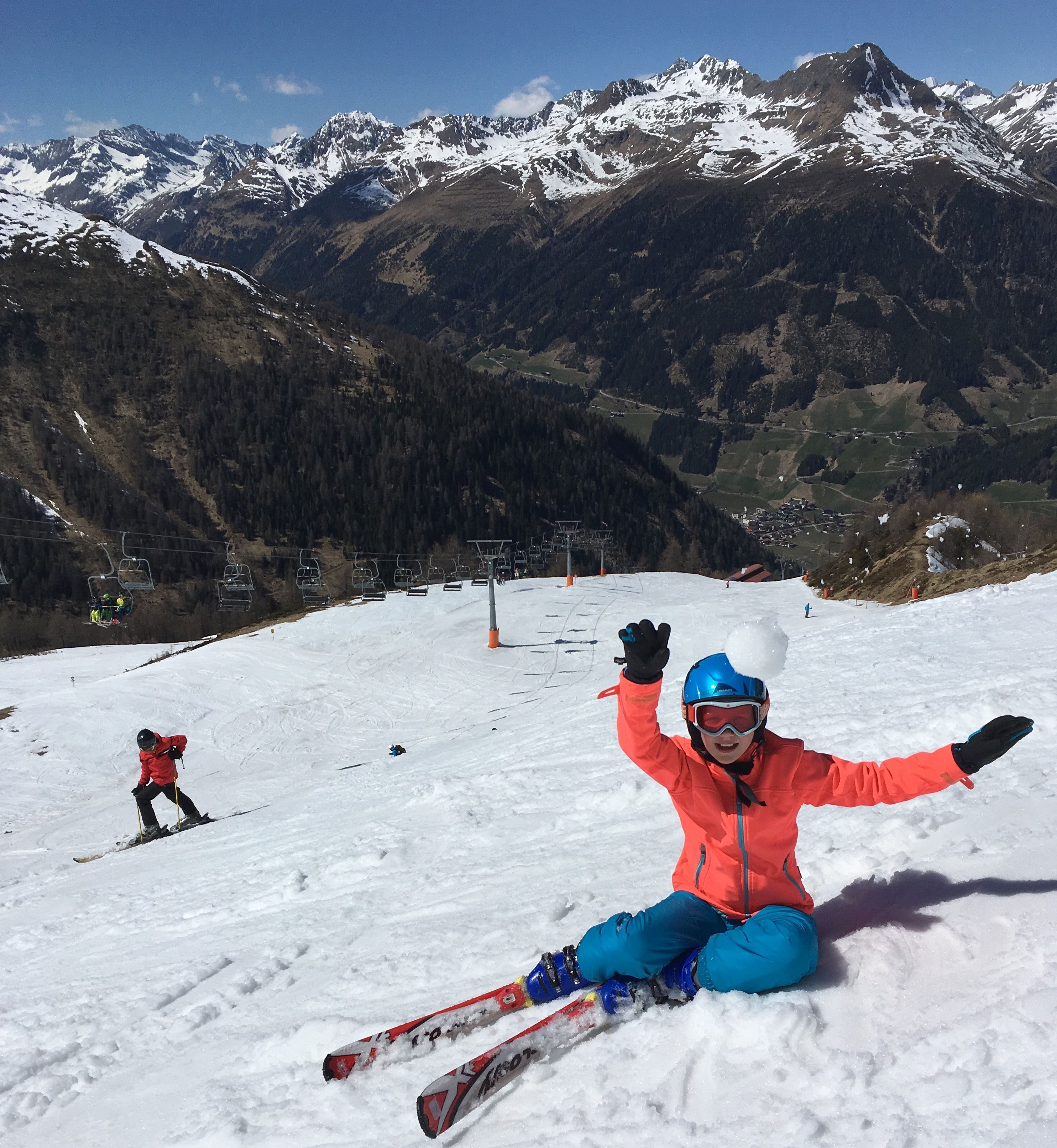A ski slope with a chairlift and a skier in the foreground.