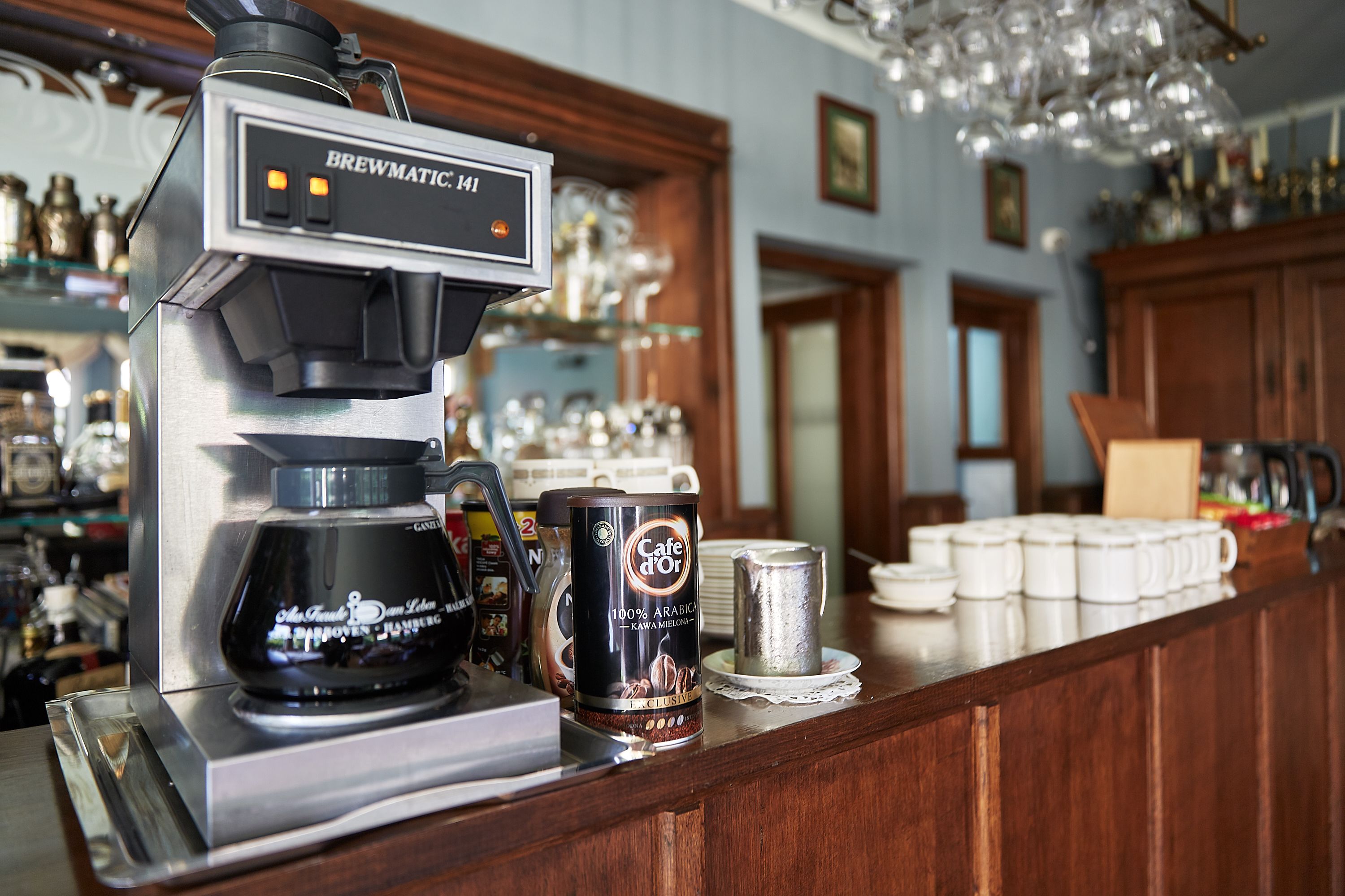 A coffee machine labeled "Brewmatic 141" and a canister of "Cafe d'Or" coffee.