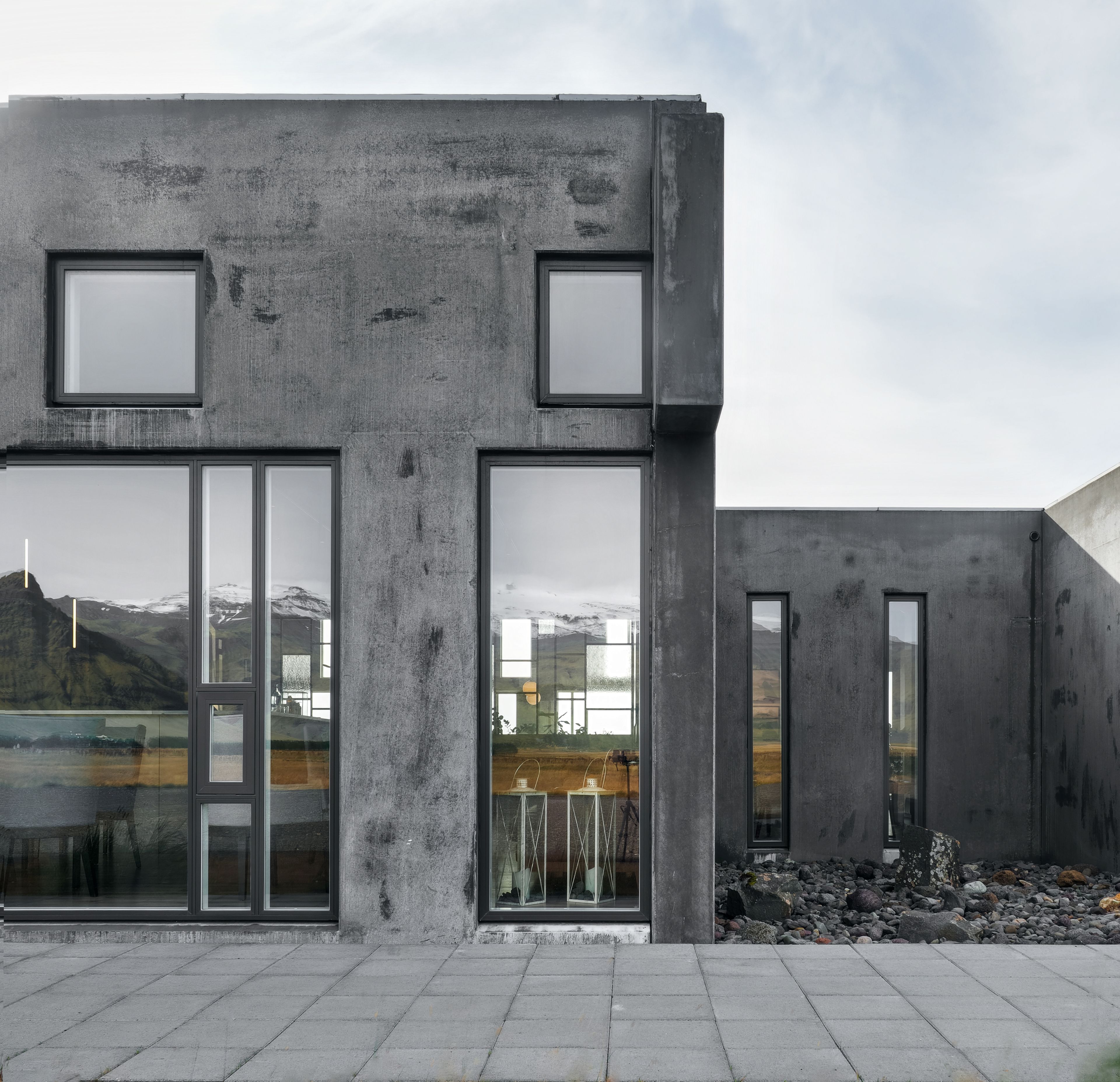 A modern building with large windows and a concrete facade.