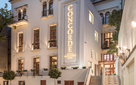 A hotel with a prominent sign reading "HOTEL CONCORDE OLD BUCHAREST HOTEL".