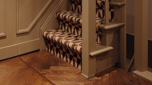 A staircase with patterned carpet and wooden steps. - Adam Downtown (Amsterdam)