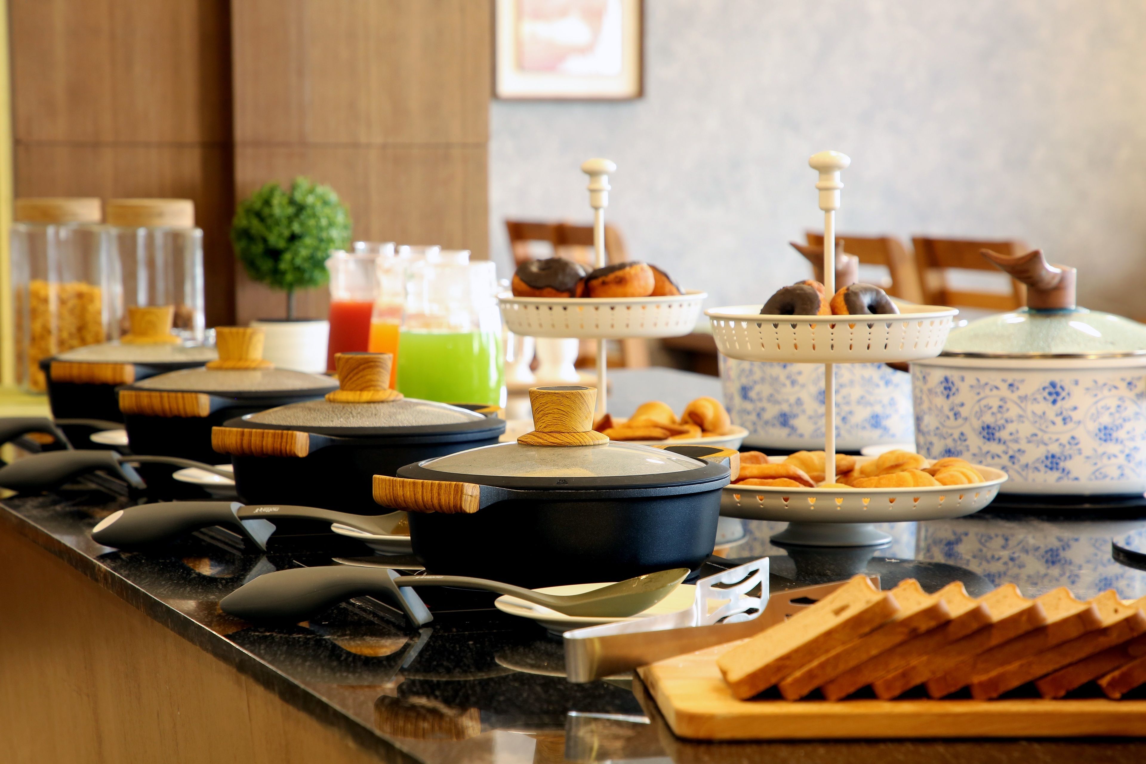 A breakfast buffet with various food items and beverages.