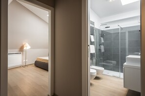 A modern bathroom with a glass shower enclosure, a toilet, and a sink. - MYSWEETPLACE - Corso Como Apartments (Milan)