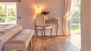 A bedroom with a wooden ceiling, a bed, a desk with a chair, and a window with curtains. - Chateau Salavaux (Vully-les-Lacs)
