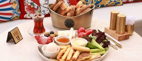 A table with a variety of food items including bread, salad, and sauces.