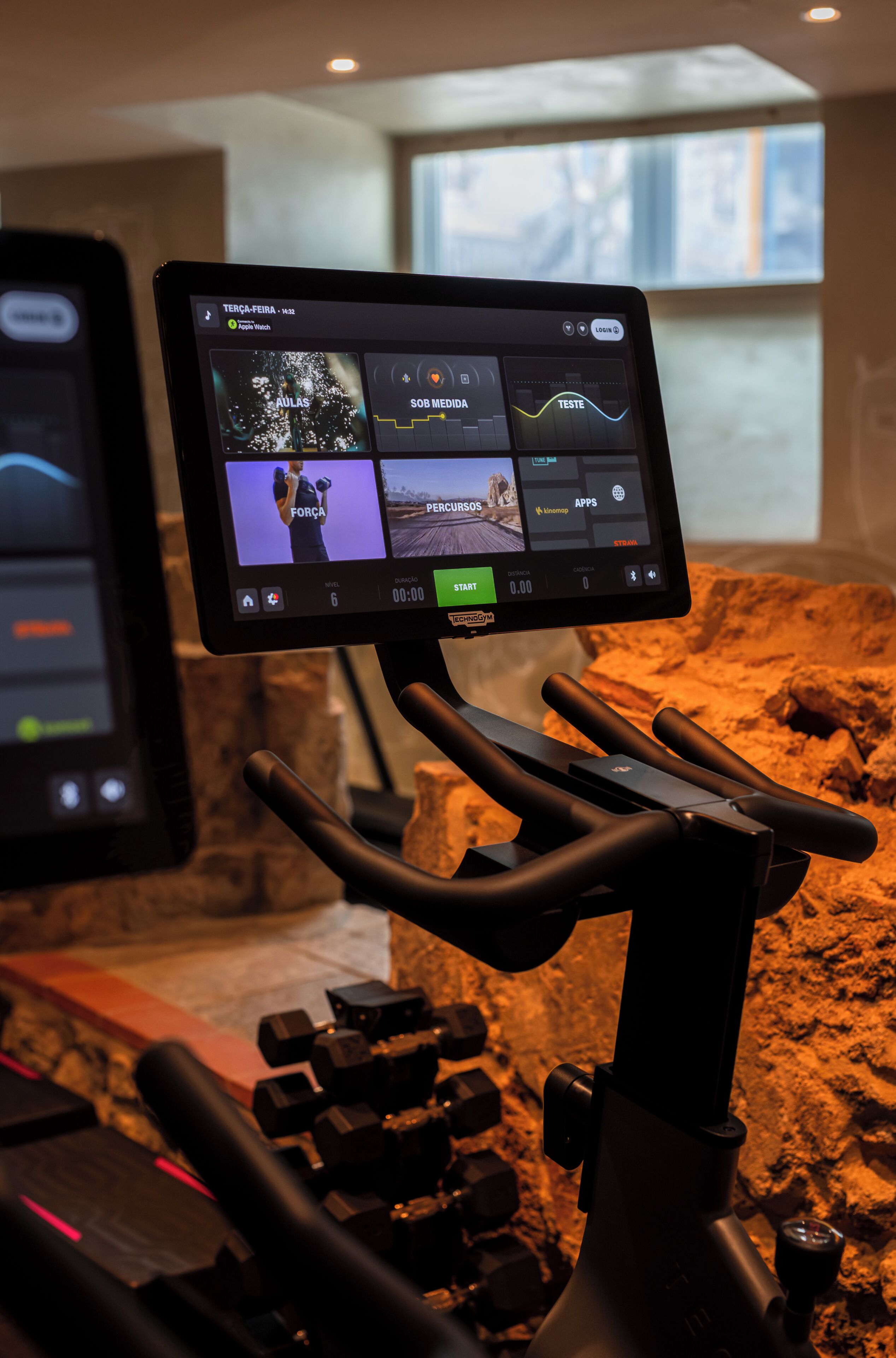 A stationary exercise bike with a digital display, handlebars, and a control panel.