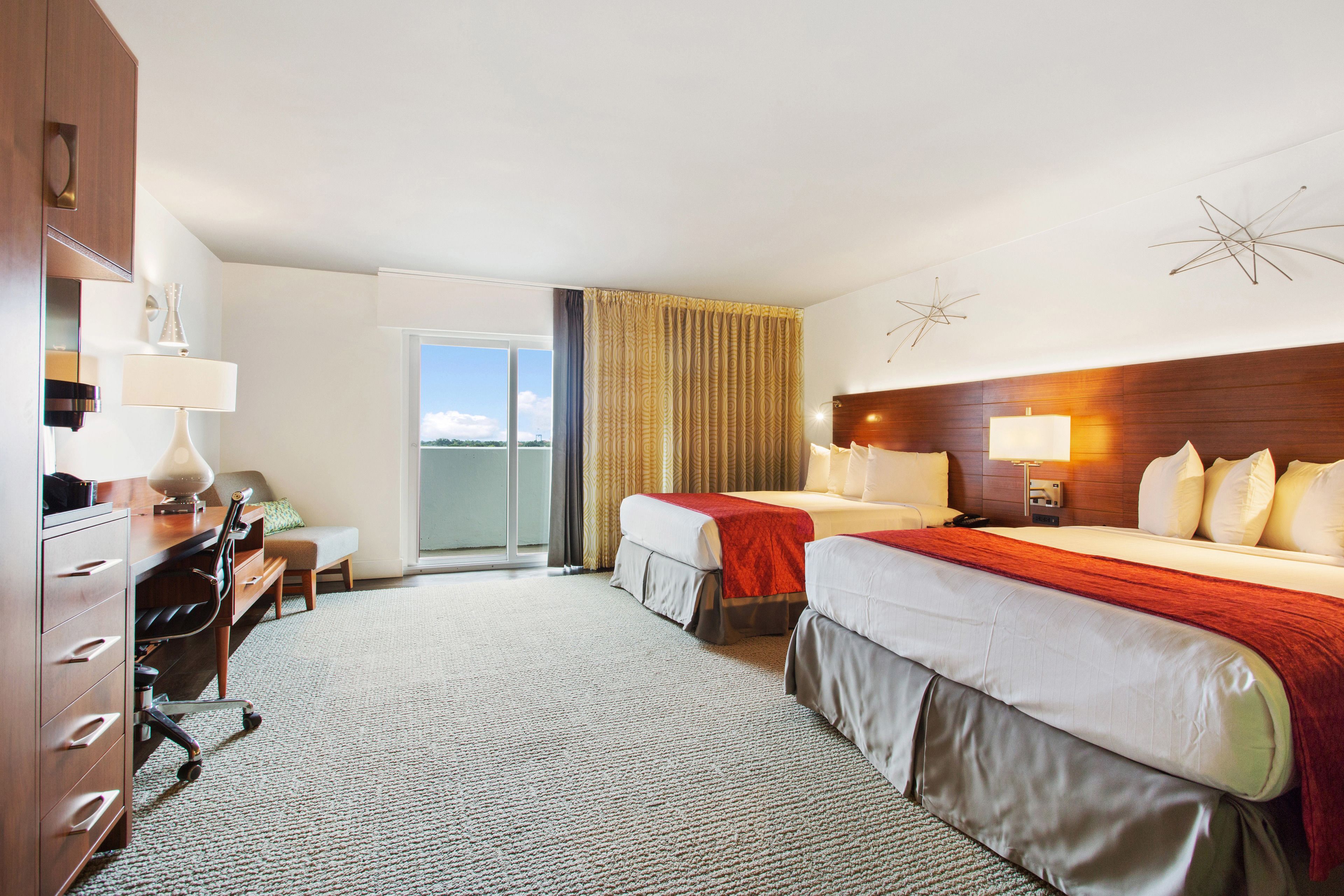 deluxe room, 2 queen beds, balcony | in-room safe, desk, laptop workspace, blackout curtains