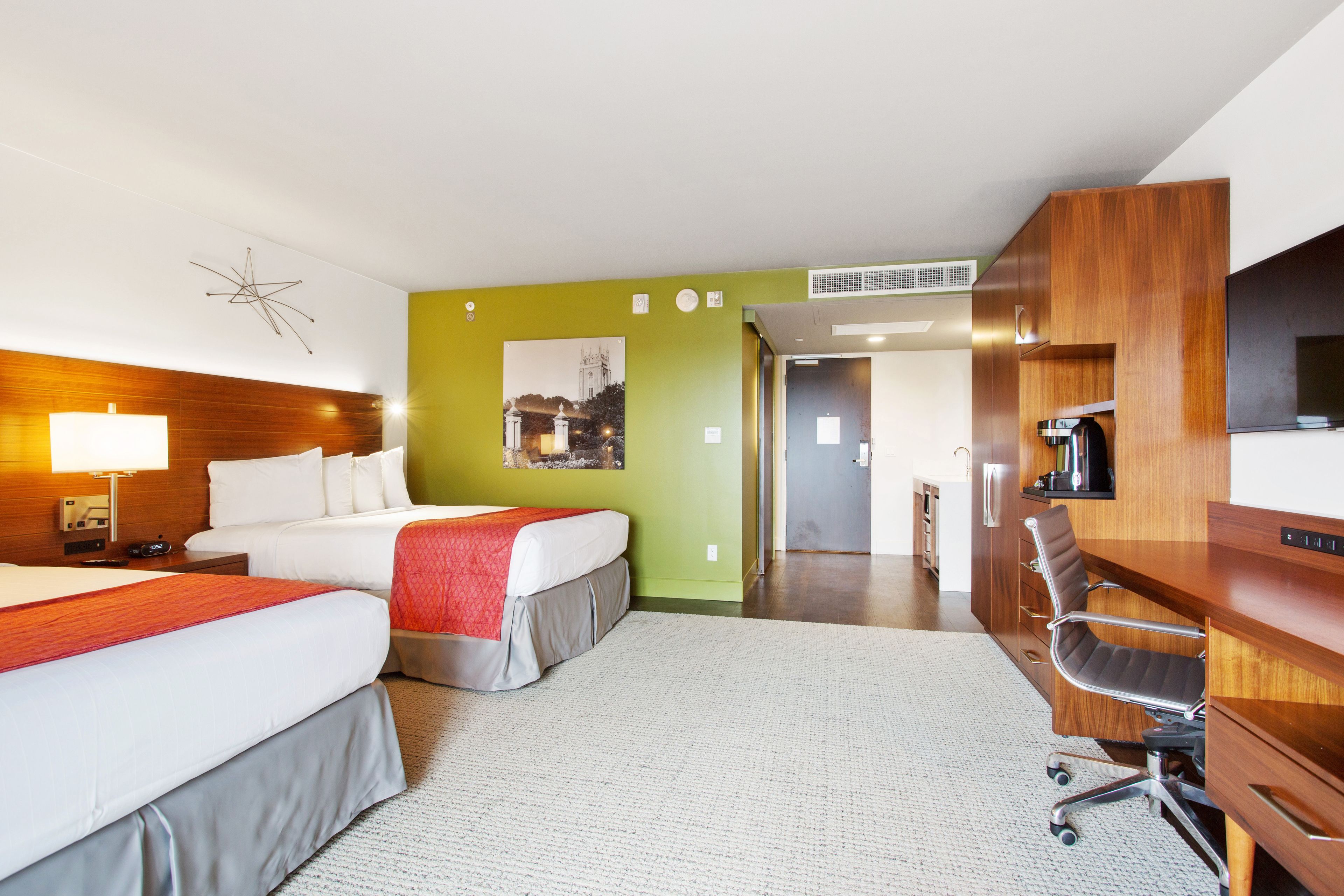 deluxe room, 2 queen beds, balcony | in-room safe, desk, laptop workspace, blackout curtains