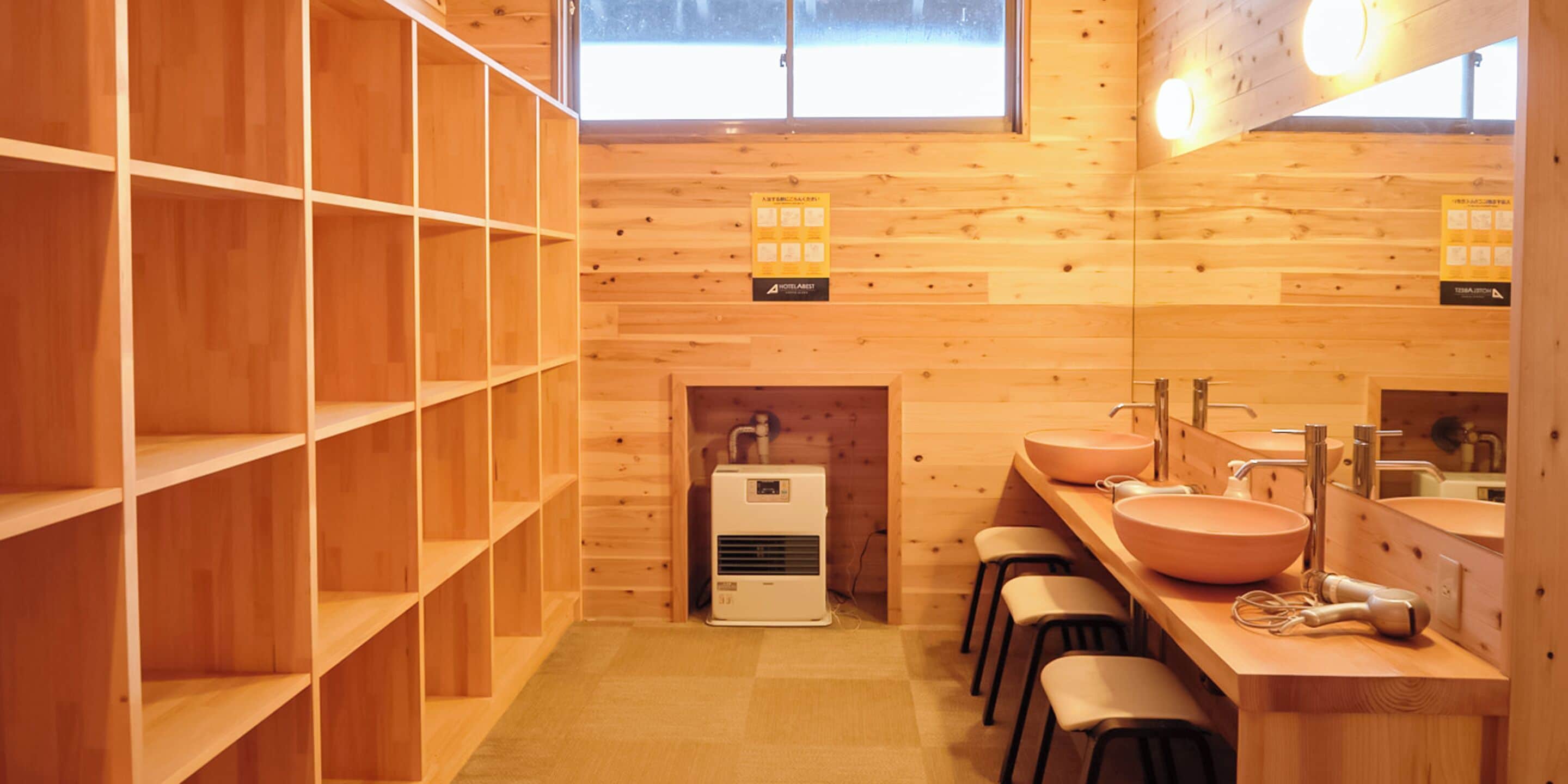 A wooden interior with shelves, a sink, and a mirror.