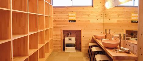 A wooden interior with shelves, a sink, and a mirror.