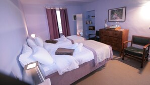 A bedroom with a bed, dresser, chair, and a shelf with books and decorative items. - Eco-Villa with garden and swimming pool UNESCO Heritage area  (Govone)