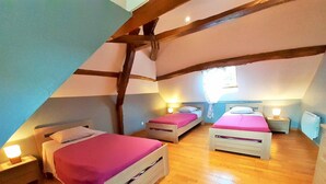 A cozy attic bedroom with two wooden beds, each with a pink bedspread and white pillows, and a small bedside table with a lamp. - Country house 3 * comfortable 20 minutes of Wi-7 pers- wonderful garden (Carville-Pot-De-Fer)