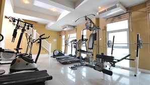 A gym with treadmills, stationary bikes, and weight machines. - Nsiri Resort & Hotel (Lam Luk Ka)