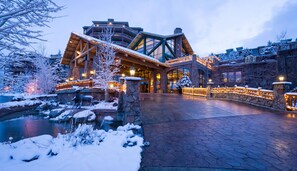 A large, multi-story hotel with a prominent entrance, stone pillars, and a snow-covered landscape. - Penthouse Suite at Westgate, w Beautiful Views, Perfect For Trail Riders & Biker (Park City)