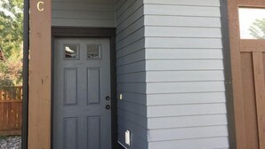 A house with a grey door and a brown mailbox. - Carriage House Cutie (KING BED) -Steps From Lake & Park (Bozeman)