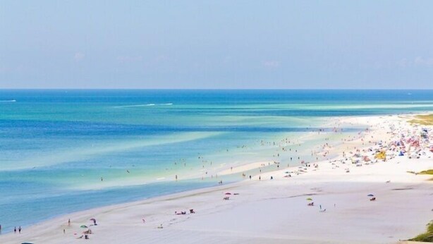 A beach with clear blue water and a sandy shore. - Oceanfront/Beachfront -Sarasota Surf  Racquet - Y Building (Sarasota)
