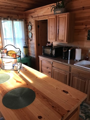 Kitchen features a microwave, toaster, and sink, perfect for meal preparation.