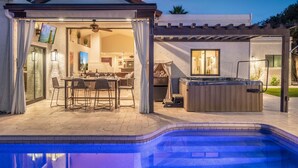 A covered outdoor area with a pool, a hot tub, and a dining setup. - Private Mediterranean Villa! Heated Pool, 2 King Suites, Casita & 8 Person Spa! (Scottsdale)