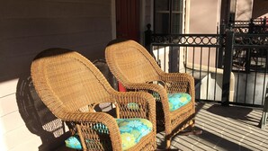 Two wicker chairs with cushions on a stone-tiled porch. - Cascading Creek / Gatehouse Condos / 2BR / 1st floor / no steps (Gatlinburg)