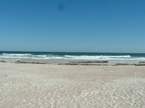 A beach with sand and waves. - FUN IN THE SUN! COZY PET FRIENDLY COTTAGE WITH SHORT WALK TO ST AUGUSTINE BEACH (St. Augustine)