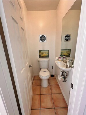 A small bathroom with a toilet, sink, and two wall-mounted fans. - Beachy Private Get-A-Way!! Large Deck facing Ocean! (Playa Del Rey)