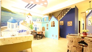 Una habitación con una mesa de comedor, sillas, un sofá y una escalera.