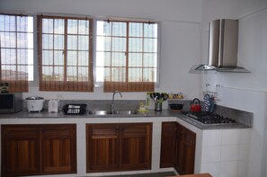 Apartment, 4 Bedrooms | Private kitchen | Fridge, microwave, oven, stovetop