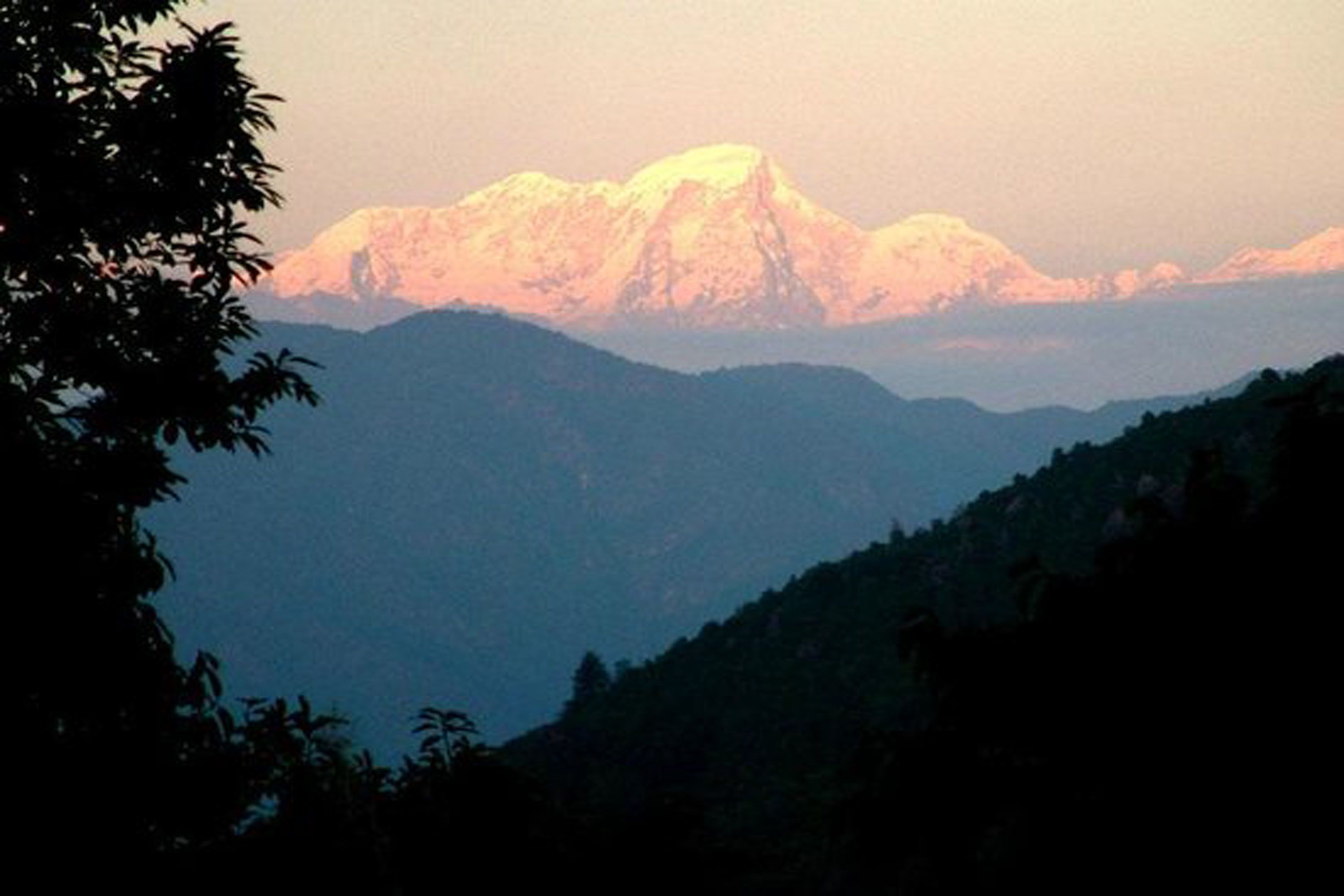 A mountain range with a prominent peak in the background.
