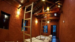 A rustic room with bunk beds, a ladder, and a wooden ceiling. - Chhaimale Resort (Dakshinkali)