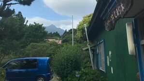 A building with a green exterior and a sign that reads "Canoe Lake". - Tomarigi - Hostel (Yakushima)