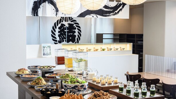 A buffet setup with various dishes and drinks, a large decorative sign, and hanging paper lanterns. - JR WEST GROUP VIA INN SHINOSAKA (Osaka)
