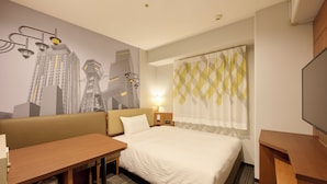 A hotel room with a bed, a desk, a chair, a television, a lamp, and a wall mural. - JR WEST GROUP VIA INN SHINOSAKA (Osaka)