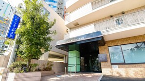 A hotel entrance with a modern design, a visible signboard, and a tree in front. - JR WEST GROUP VIA INN SHINOSAKA (Osaka)