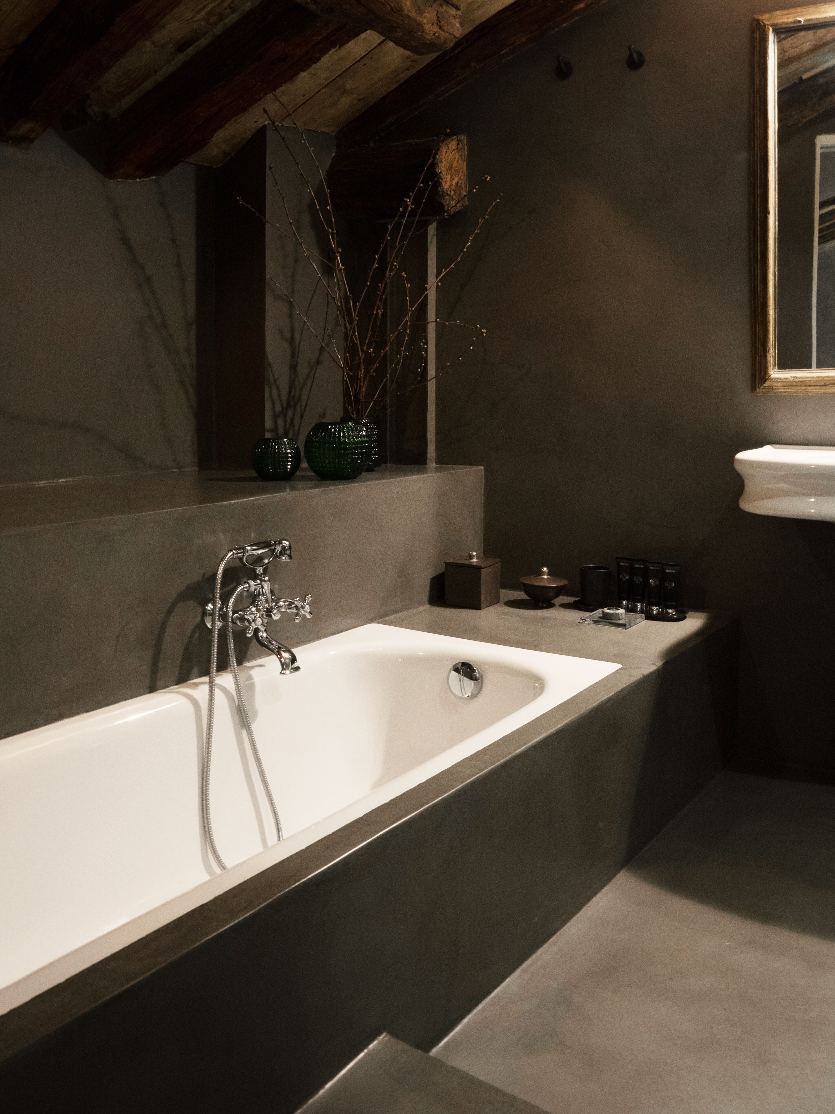 A modern bathroom with a freestanding bathtub, a vanity with a sink, and a mirror above the sink.