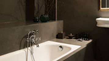 A modern bathroom with a freestanding bathtub, a vanity with a sink, and a mirror above the sink.