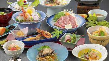 A variety of dishes arranged on a table, including seafood, vegetables, and other food items.