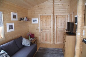 Cabin, 2 Bedrooms | Living area | Flat-screen TV, DVD player - Skarðás Country Cabins (Egilsstaðir)