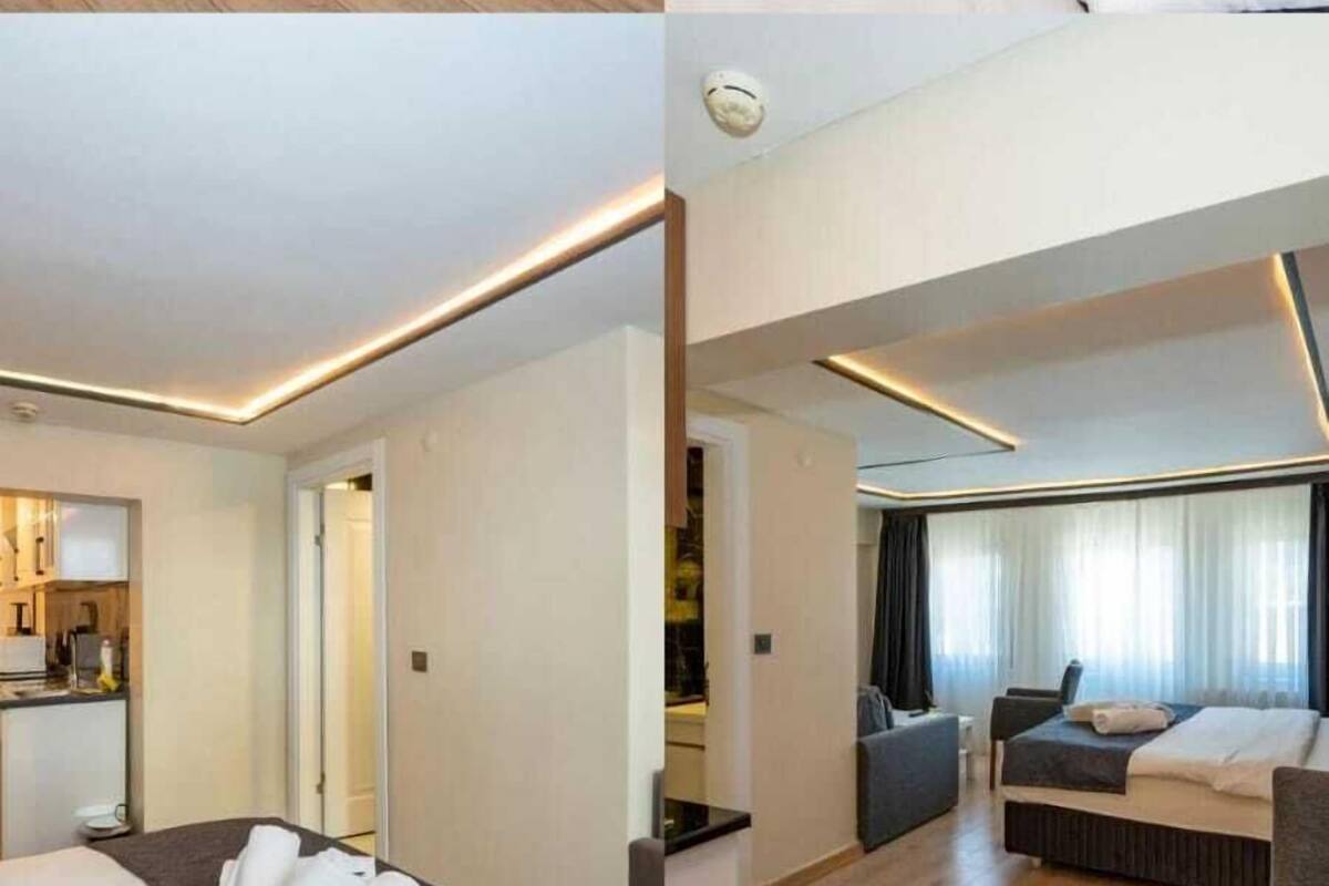 A hotel room with a large bed, a desk, and a shower.