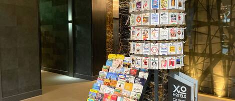 A display of travel brochures and a sign for 'MINIARDS maximum info discounts & rules'.