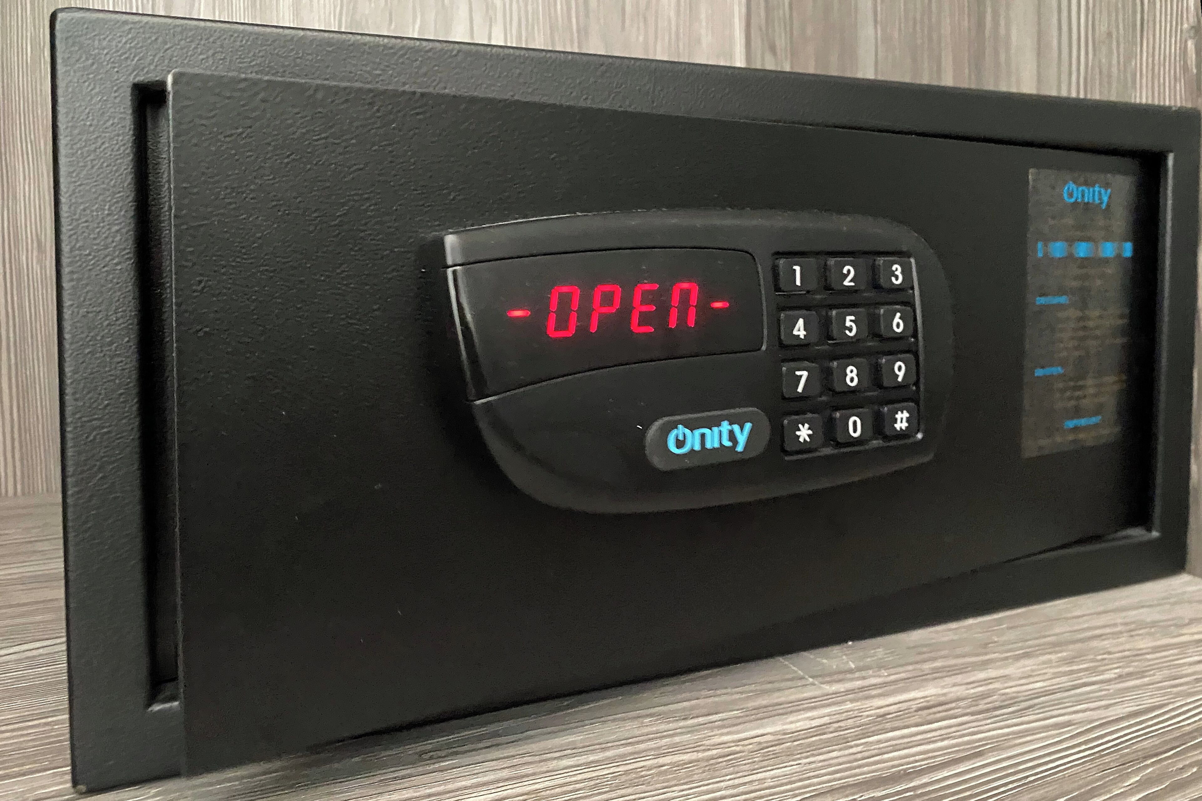 A black electronic keypad with a red display reading "OPEN" and a numeric keypad below it.