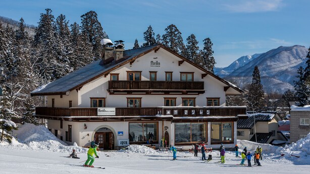 A large building with a balcony and a sign that reads "Marillen." - Marillen Hotel (Hakuba)
