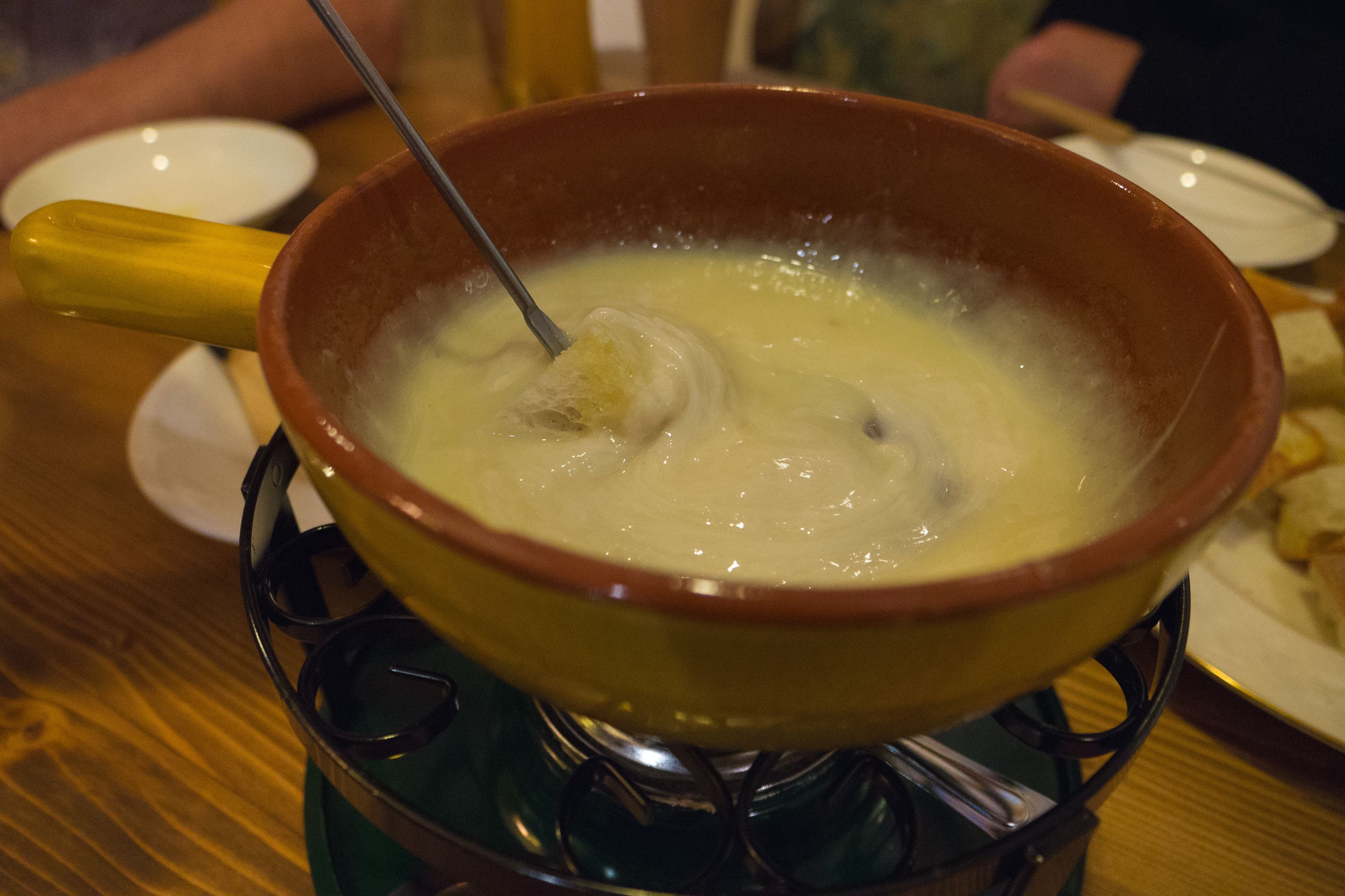A bowl of soup on a stove.