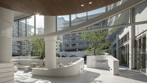 A spacious indoor area with high ceilings, large windows, and modern architectural elements. - Terra Nara (Pattaya)